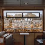 Interior shot of an empty ferry cabin with a scenic view of Adalar's landscape in Istanbul, Turkey.